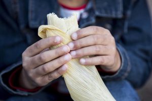 Mikayla Irby, 6, eats a tamale during the sixth annual Tamales Holiday Festival at the Pearl Brewery on December 5, 2015 in San Antonio, Texas.
