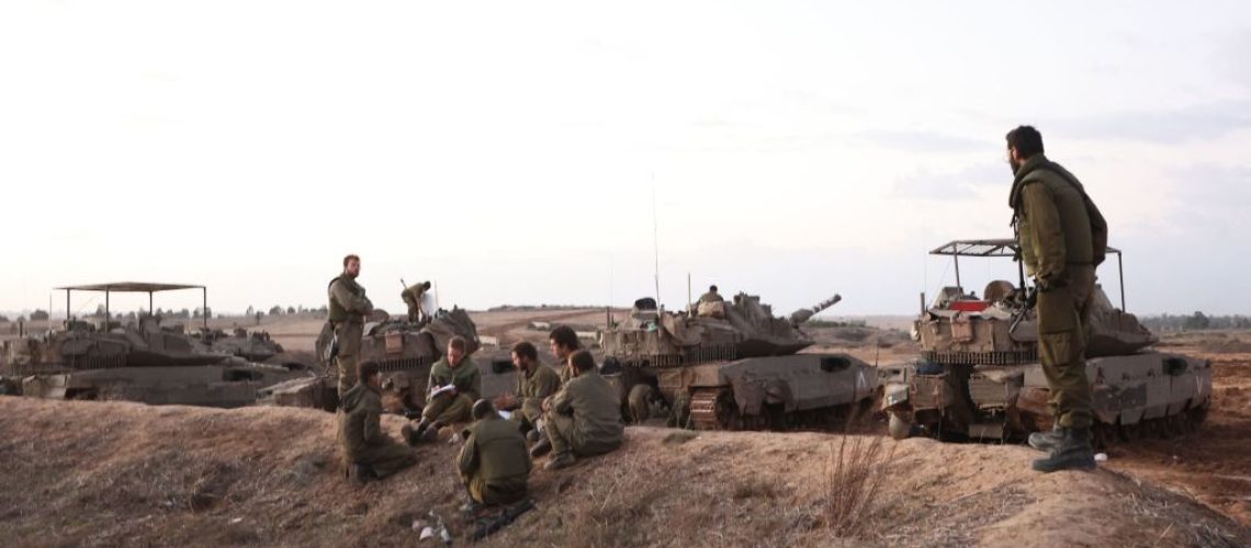 A picture taken from southern Israel near the border with the Gaza Strip on November 20, 2023, shows Israeli soldiers stationed near the Palestinian enclave, amid ongoing battles between Israel and the Palestinian Hamas movement. (Photo by GIL COHEN-MAGEN / AFP) (Photo by GIL COHEN-MAGEN/AFP via Getty Images)