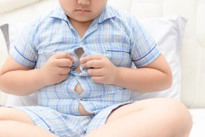 boy overweight. Tight shirt of pajamas, healthy concept