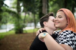 Lesbian couple embracing at park
